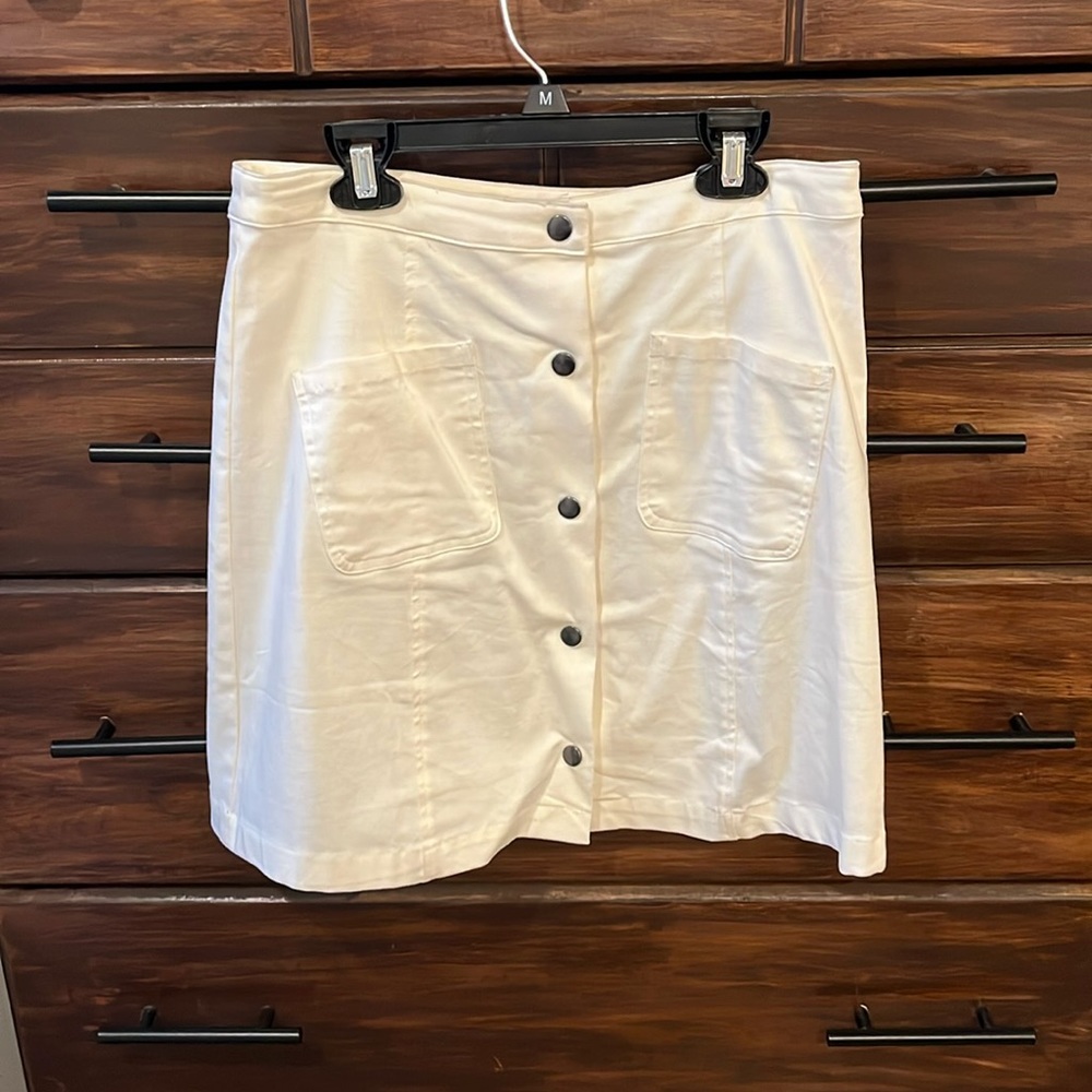 White skirt with button and pocket detailing